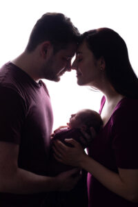 Parents holding Newborn Baby